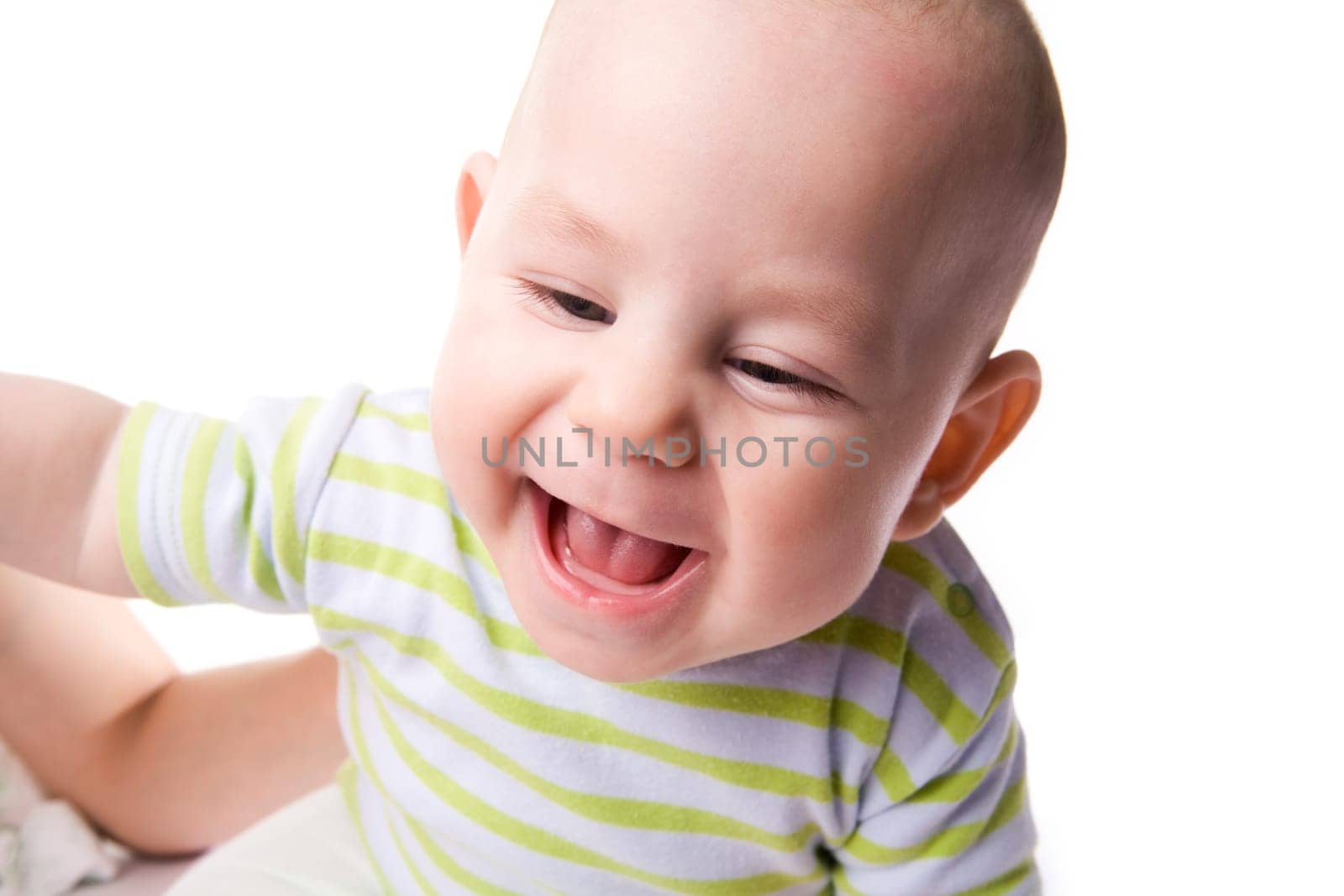 Photo of happy baby laughing over white background