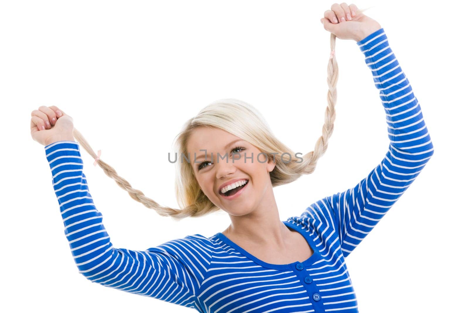 Above view of happy girl with raised arms holding her pigtails over white background