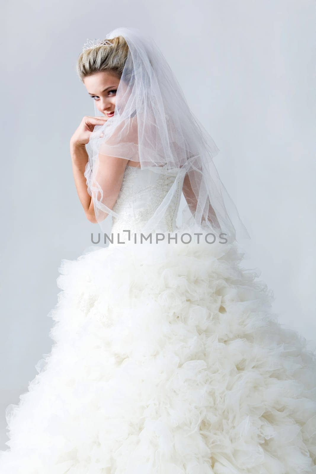 Portrait of beautiful timid fiancee in white nuptial dress