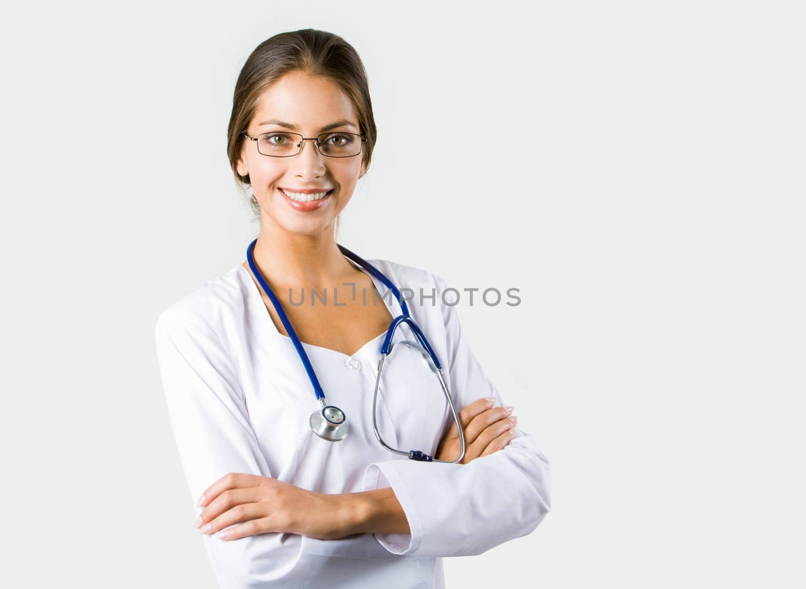 Portrait of happy clinician in eyeglasses looking at camera and smiling