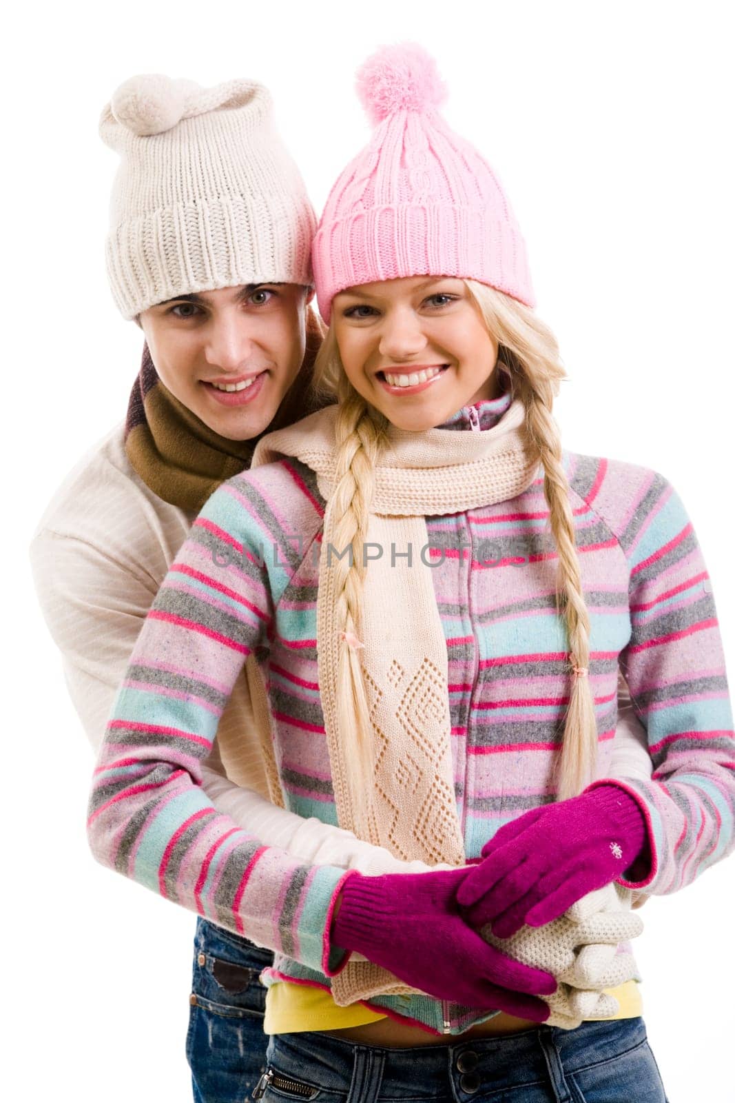 Portrait of happy young couple in warm clothes over white background