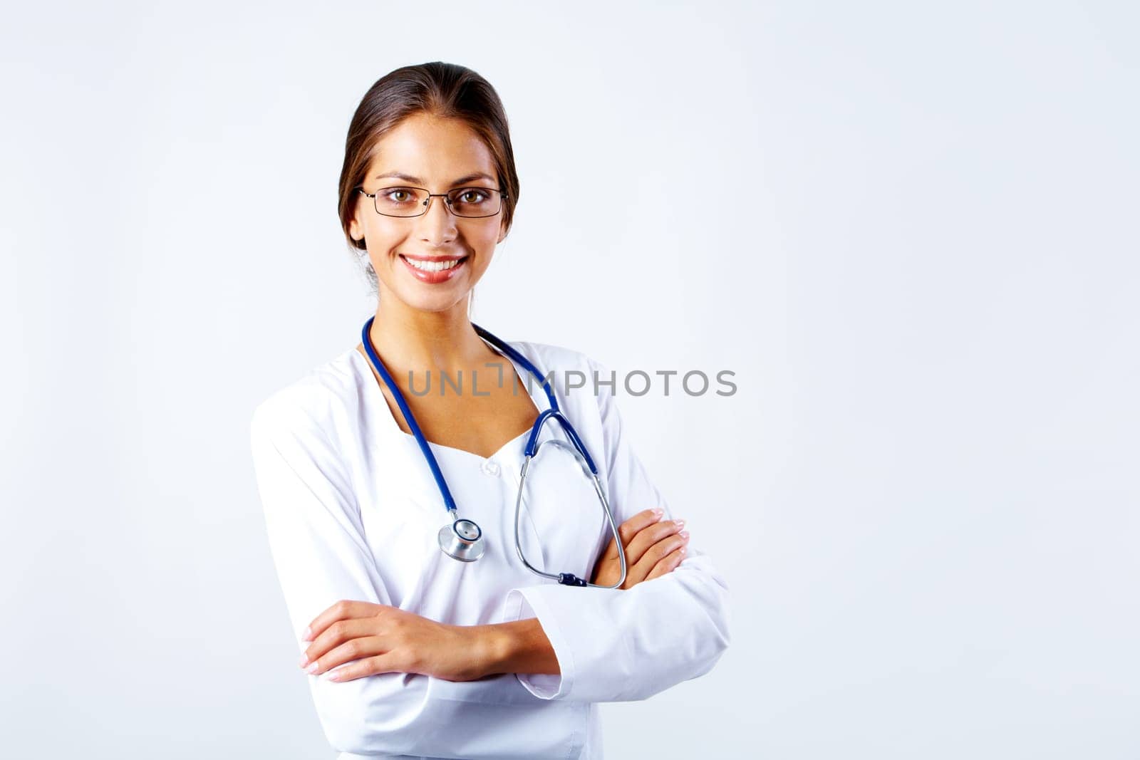 Portrait of happy clinician in eyeglasses looking at camera and smiling