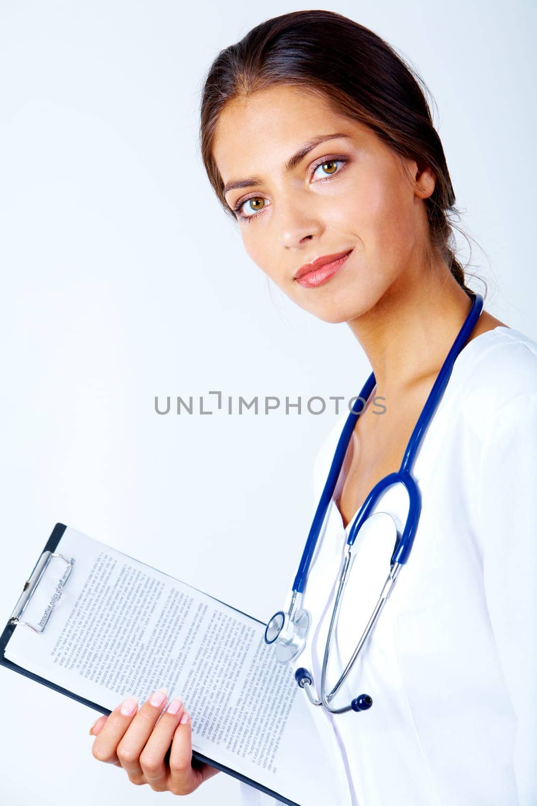 Portrait of pretty assistant with clipboard in hand looking at camera over white background
