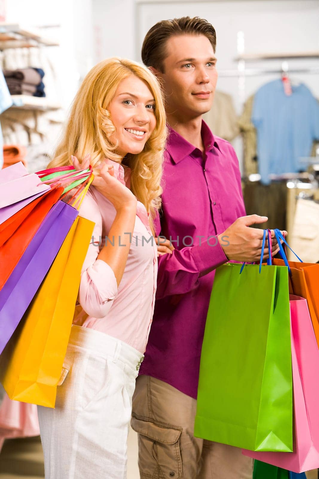 Image of woman holding by mans hand in the shop