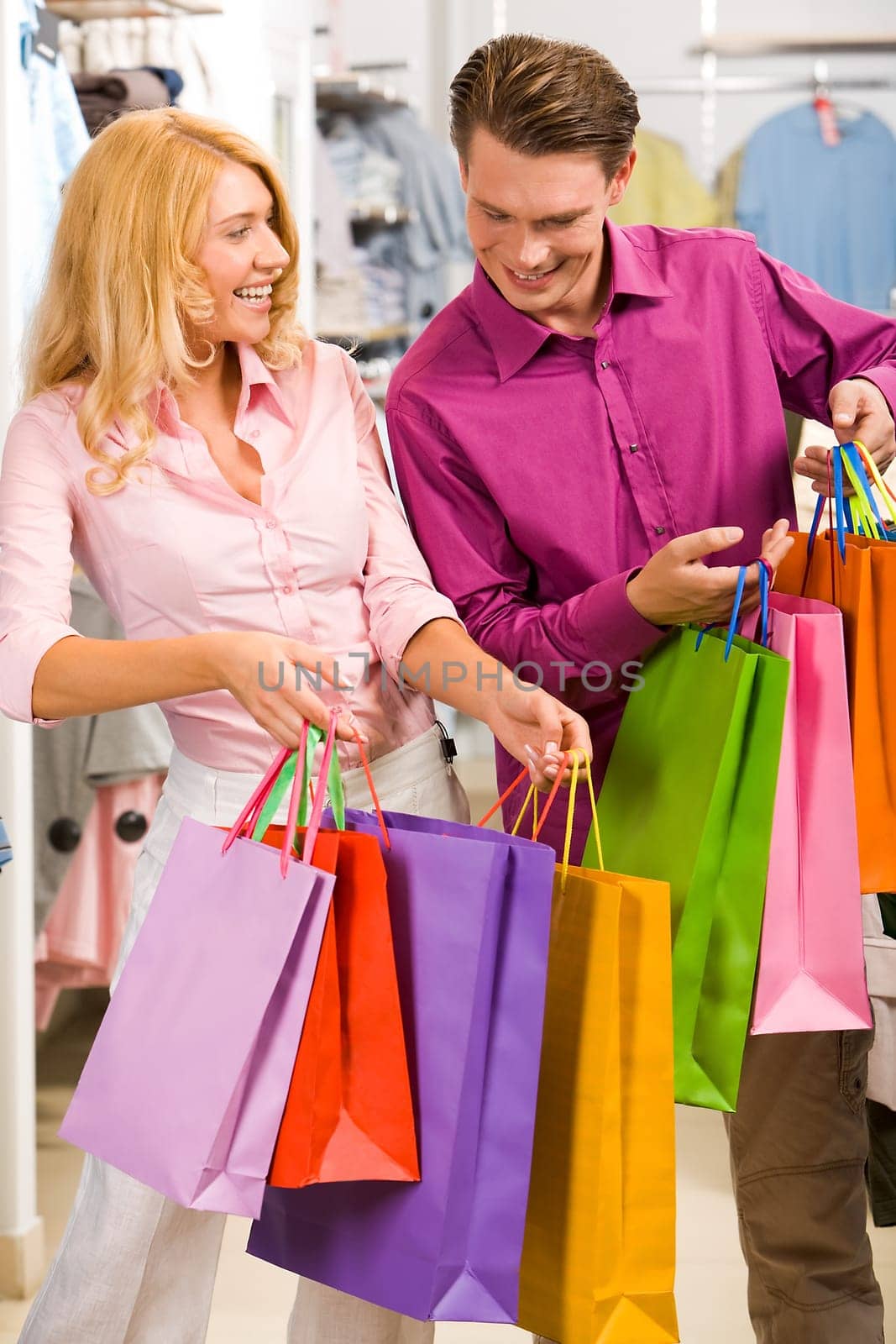 Image of woman showing to man what she bought in the shop