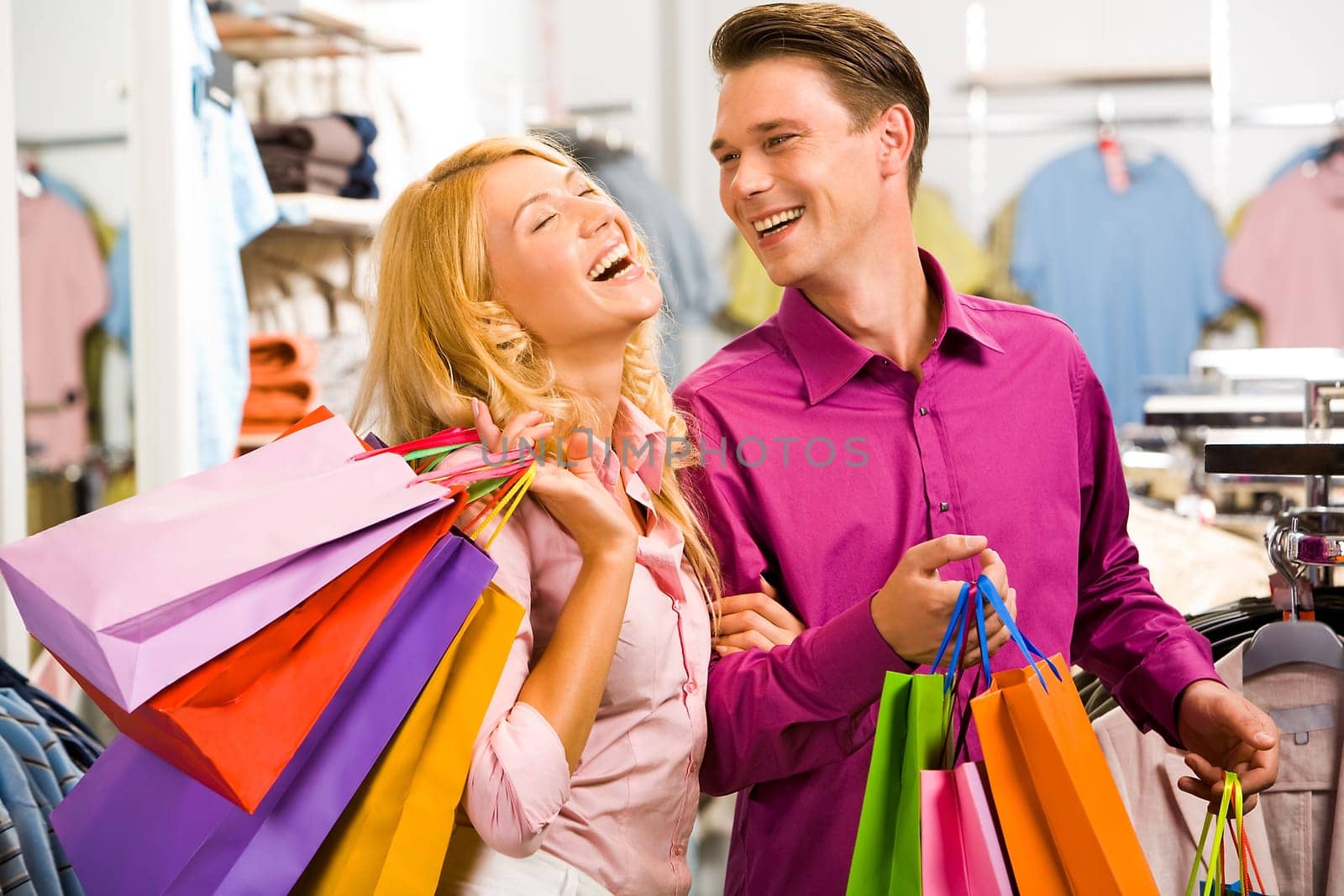 Portrait of happy woman laughing with her boyfriend near by