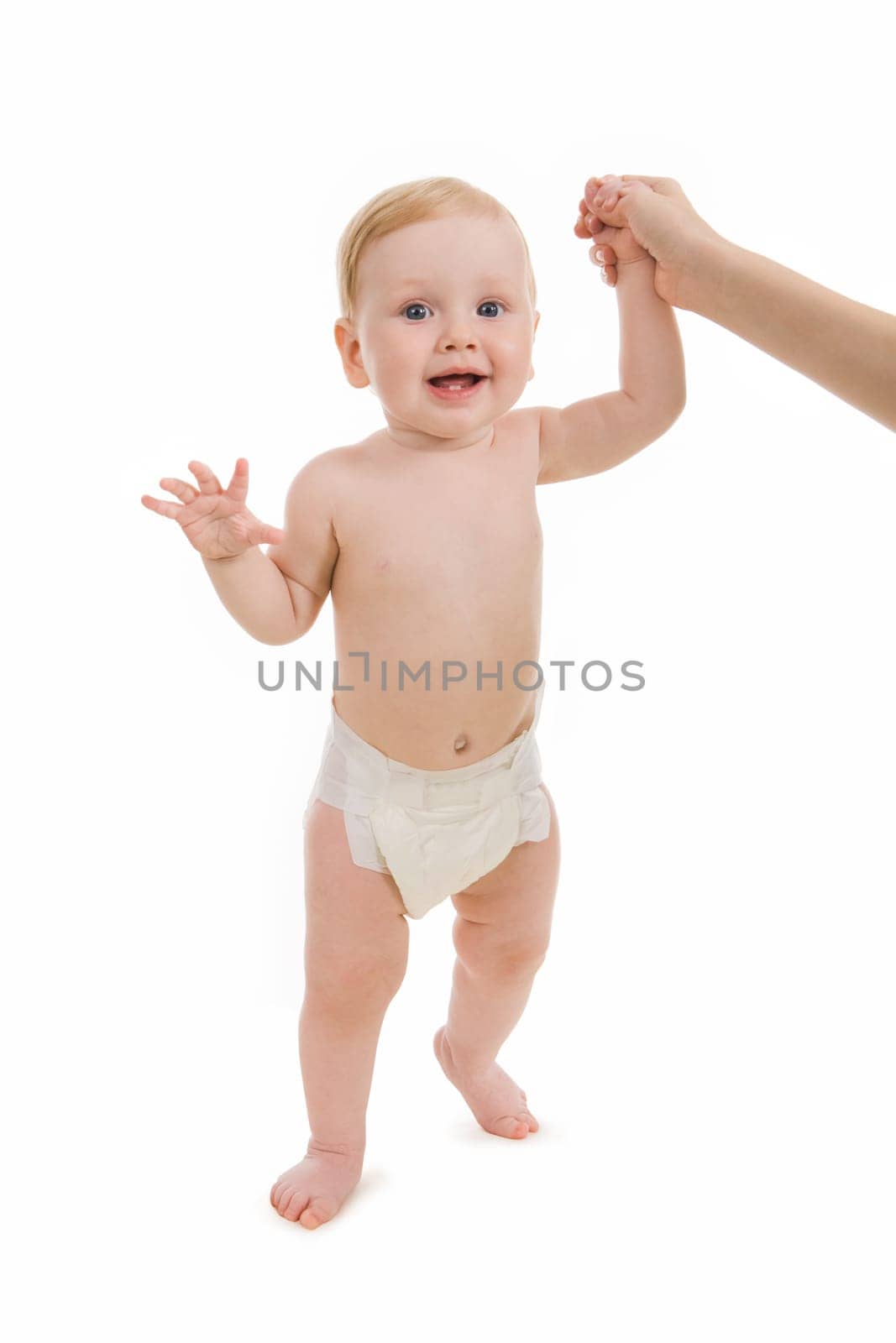 Photo of happy baby trying to walk with help of her mother