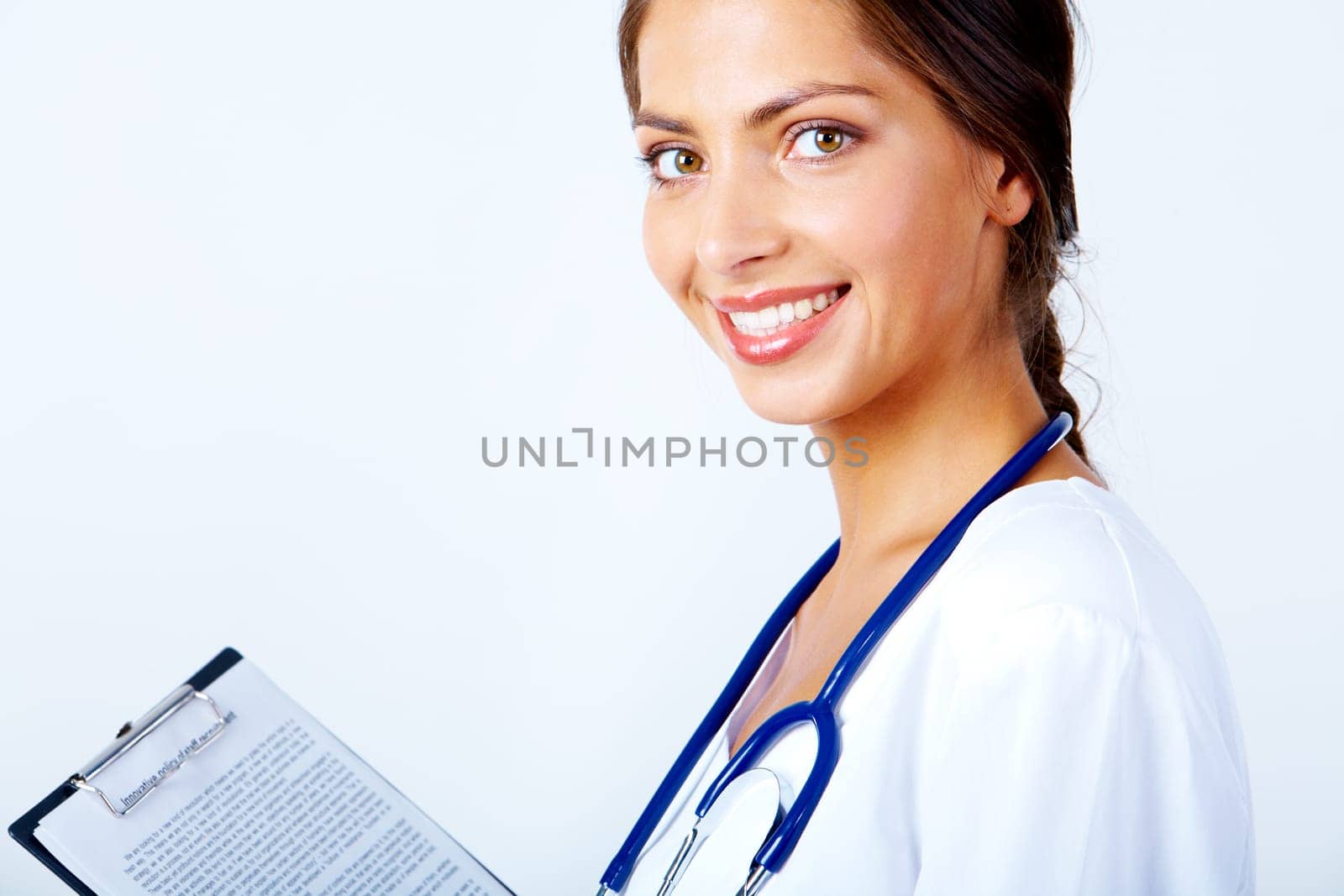 Portrait of pretty female assistant with clipboard looking at camera on white background