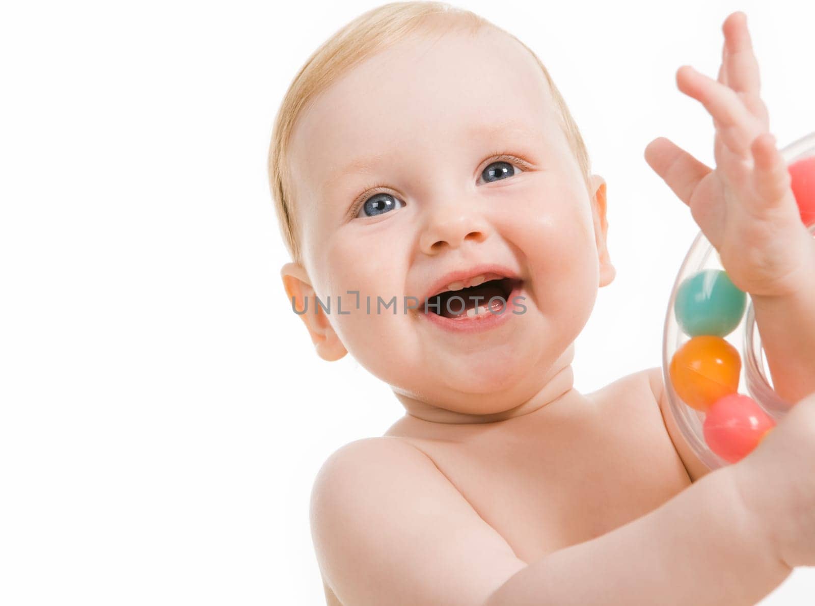 Photo of happy baby playing with toy and laughing over white background