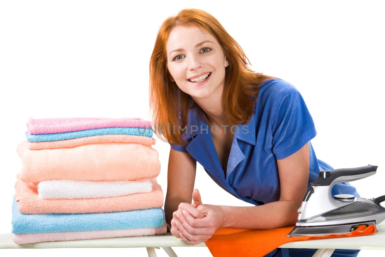 Portrait of joyful female looking at camera during housework