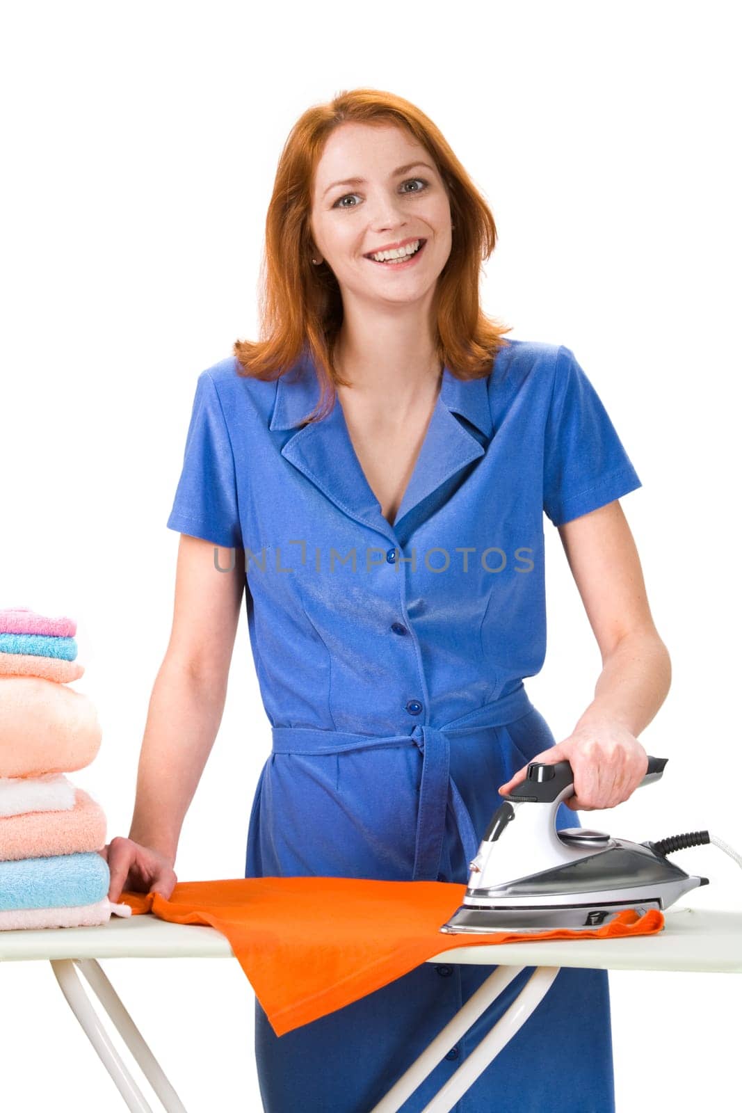 Portrait of joyful female ironing towels over white background