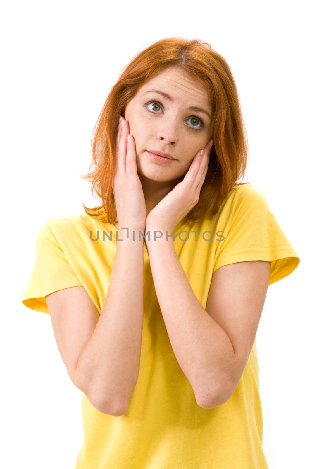 Portrait of young female touching her face in confusion