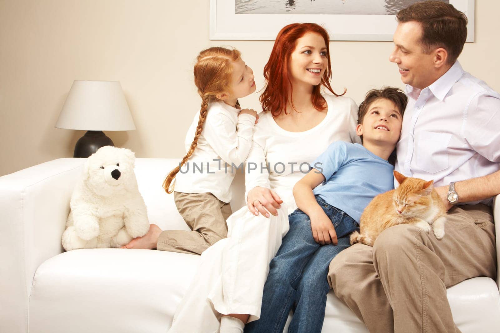 Friendly family members sitting on comfortable sofa and communicating at home