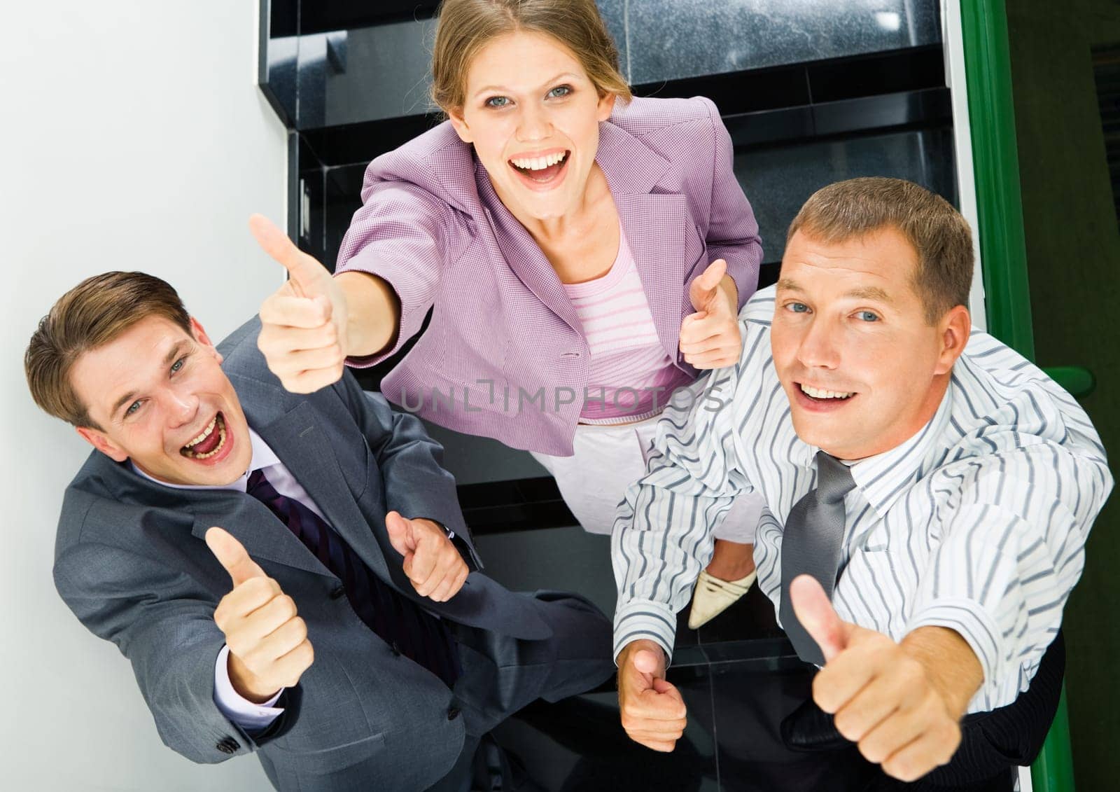 Portrait of business people giving the thumbs-up sign