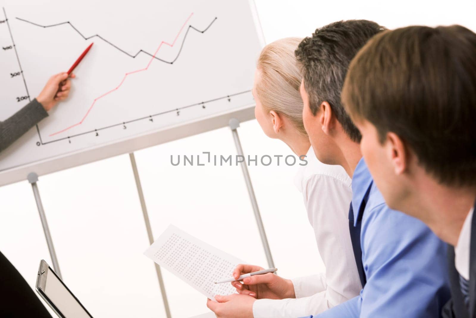 Image of business partners listening to report at working meeting
