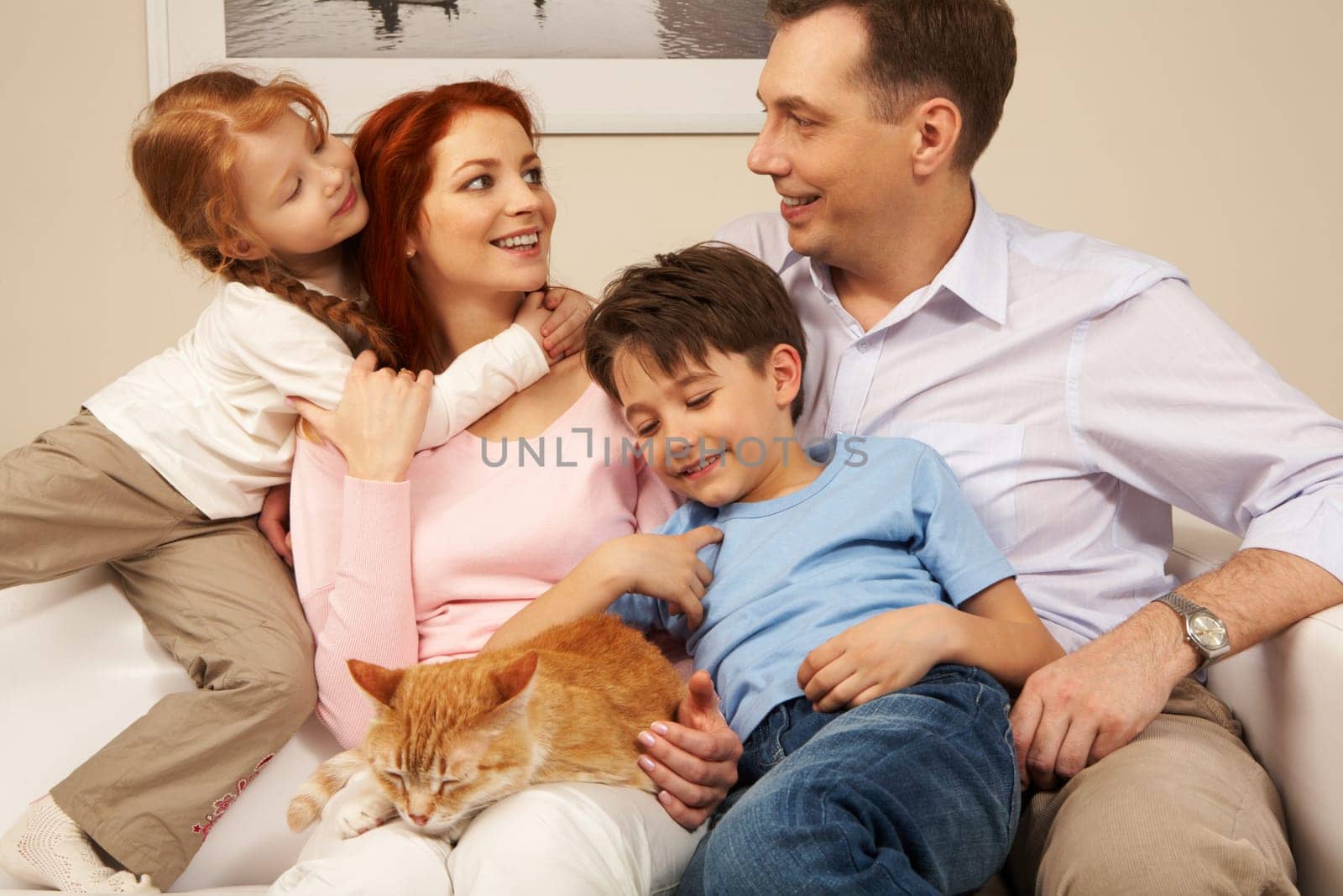 Portrait of affectionate parents and their children enjoying weekend day at home
