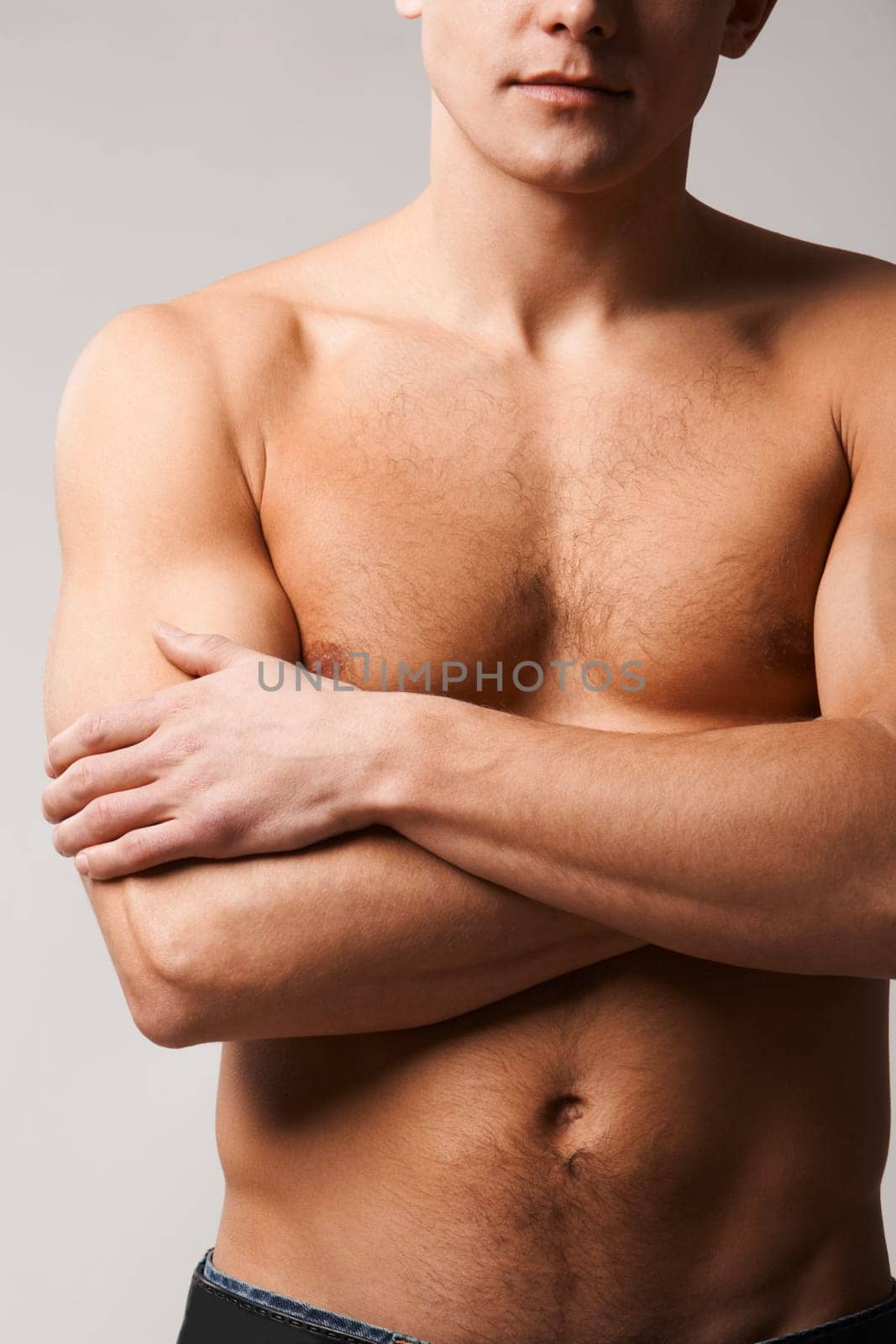 Image of shirtless man crossing his arms on chest