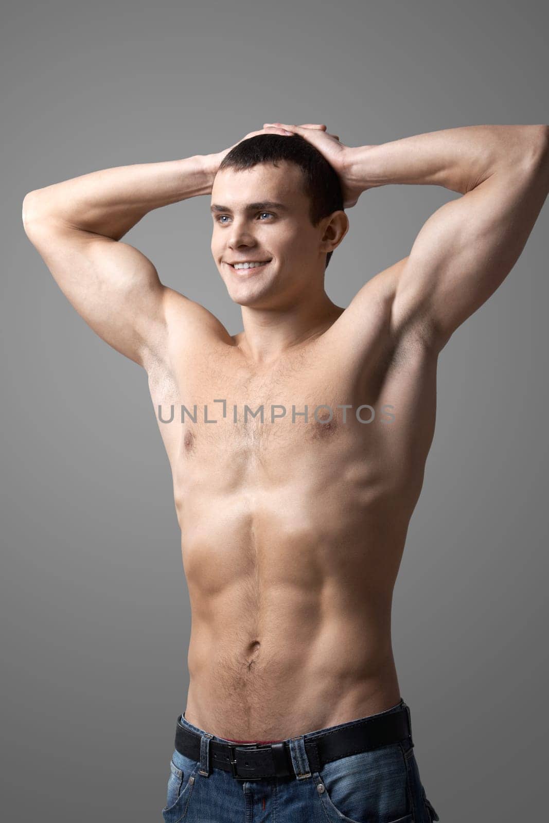 Image of handsome man with bare torso posing before camera