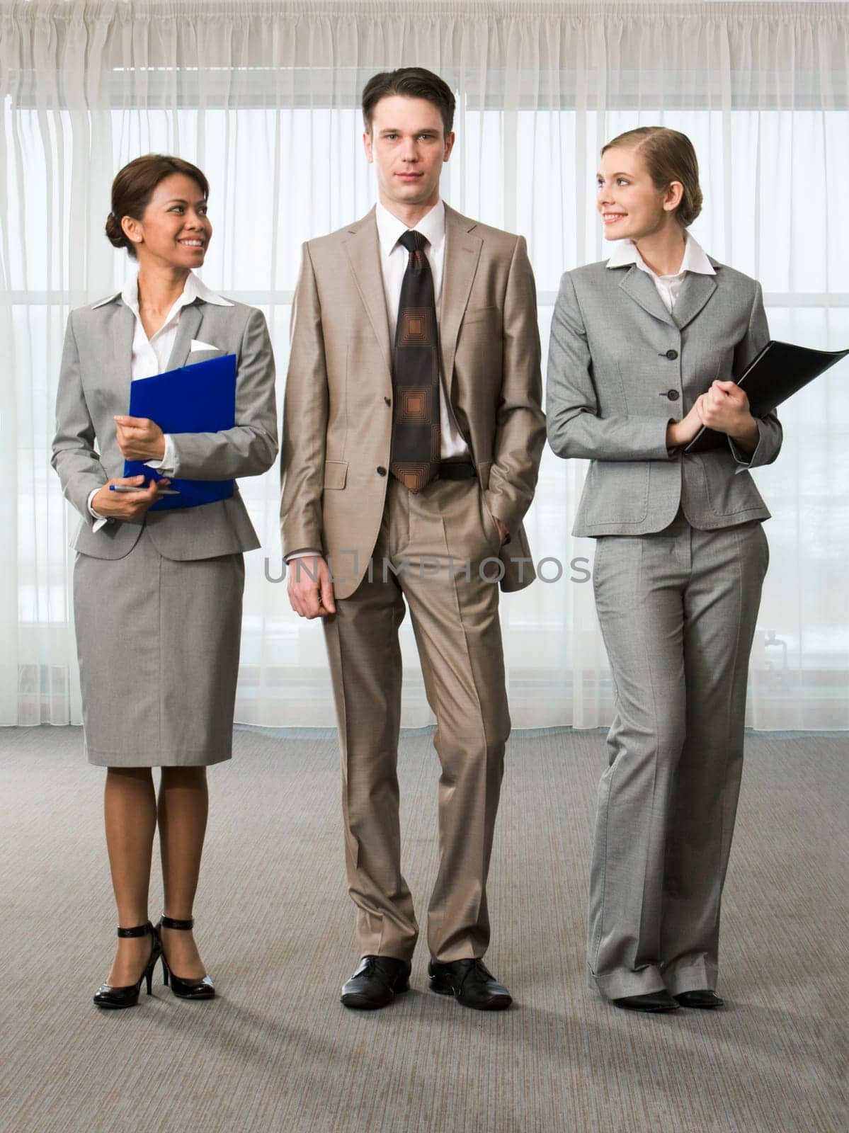 Elegant business women looking at successful man in suit