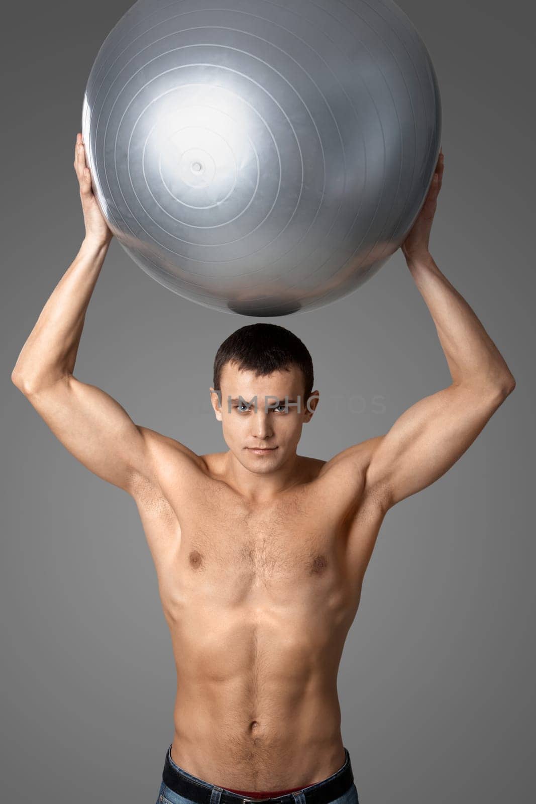 Portrait of handsome man with big ball looking at camera