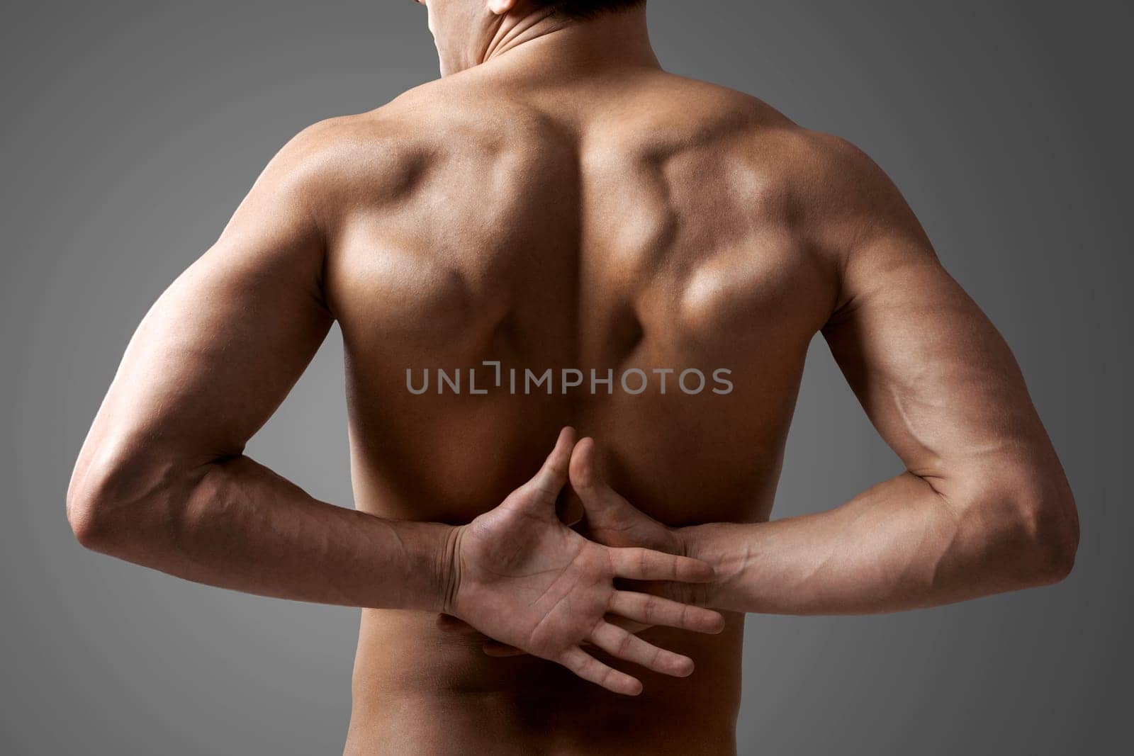 Back view of handsome man with hands behind