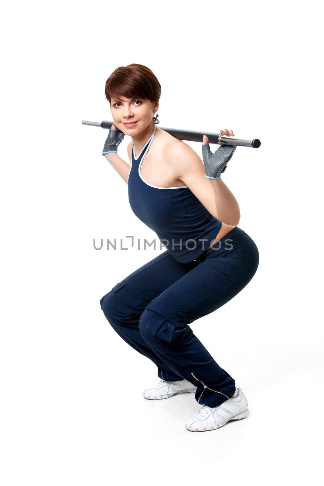 Image of sporty girl standing on the floor and doing exercise with plank