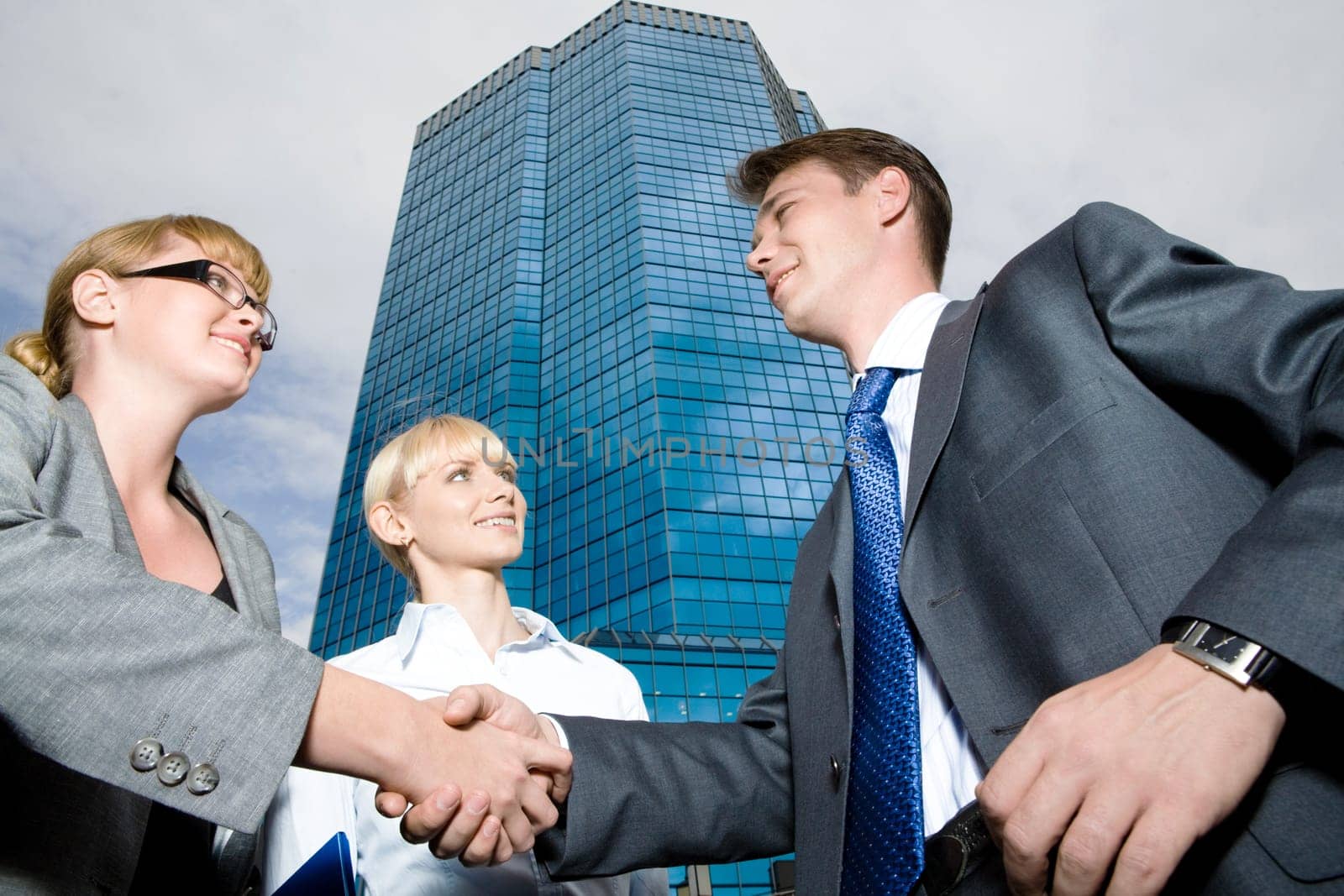 Below view of leaders handshaking after signing contract