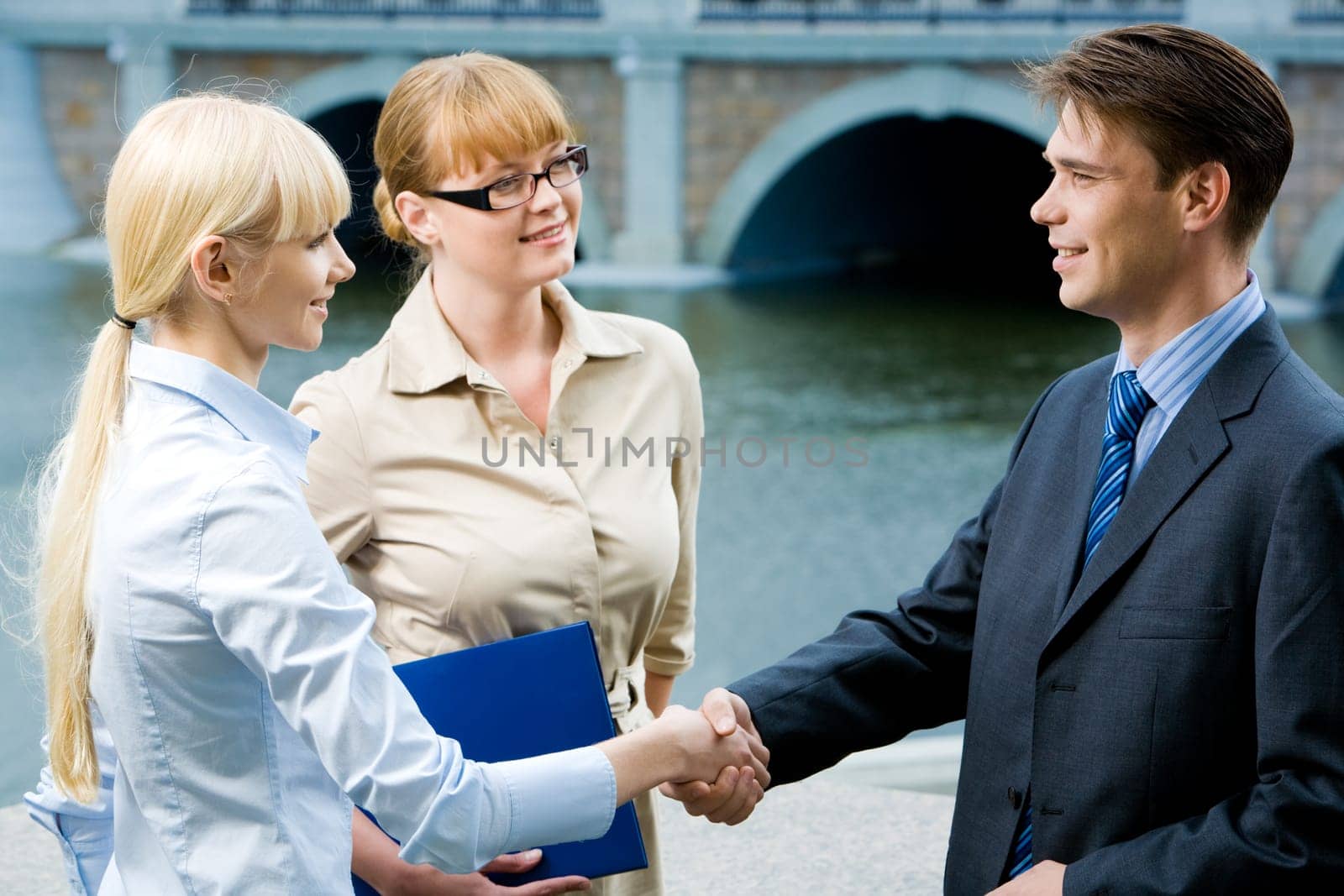 Photo of happy partners expressing trust by handshake after concluding bargain