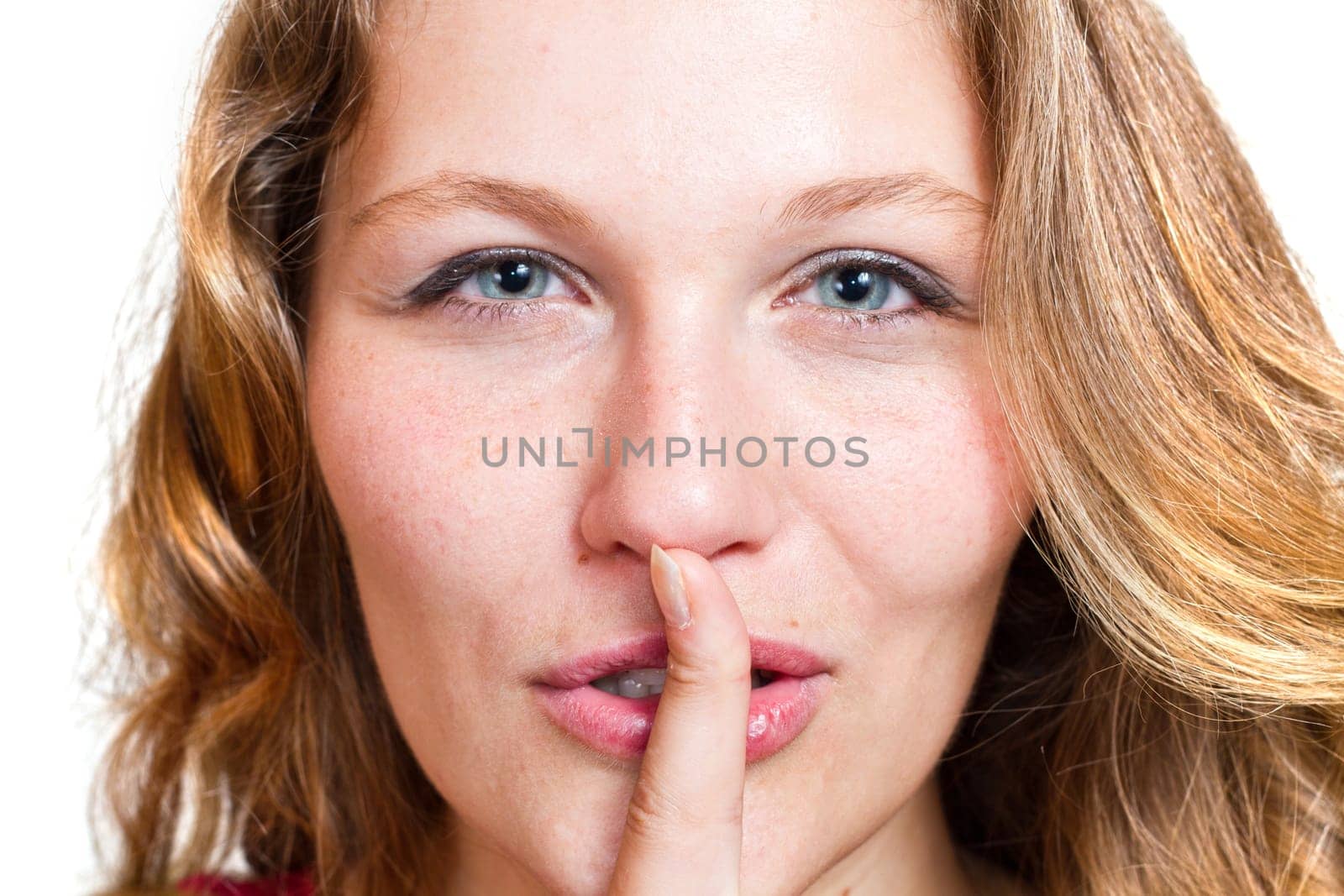 blonde girl doing a sign of being quiet- hush