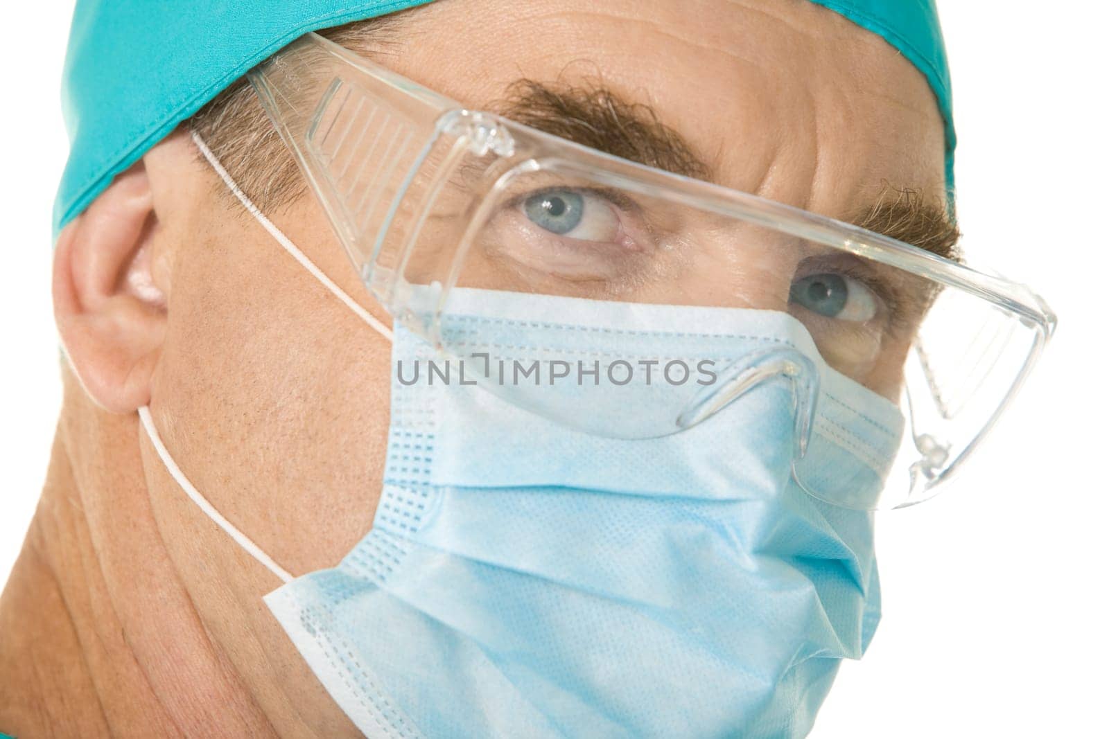 Close-up of surgeon wearing mask over white background