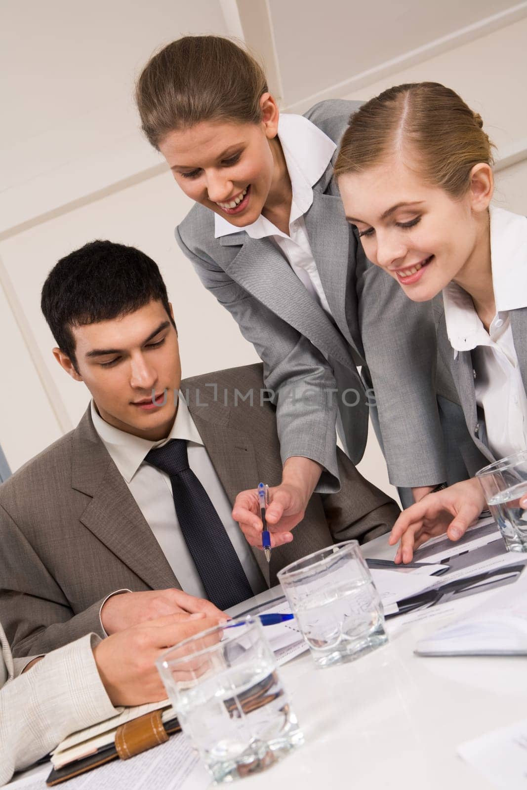 Portrait of busy people talking about new project and planning their work