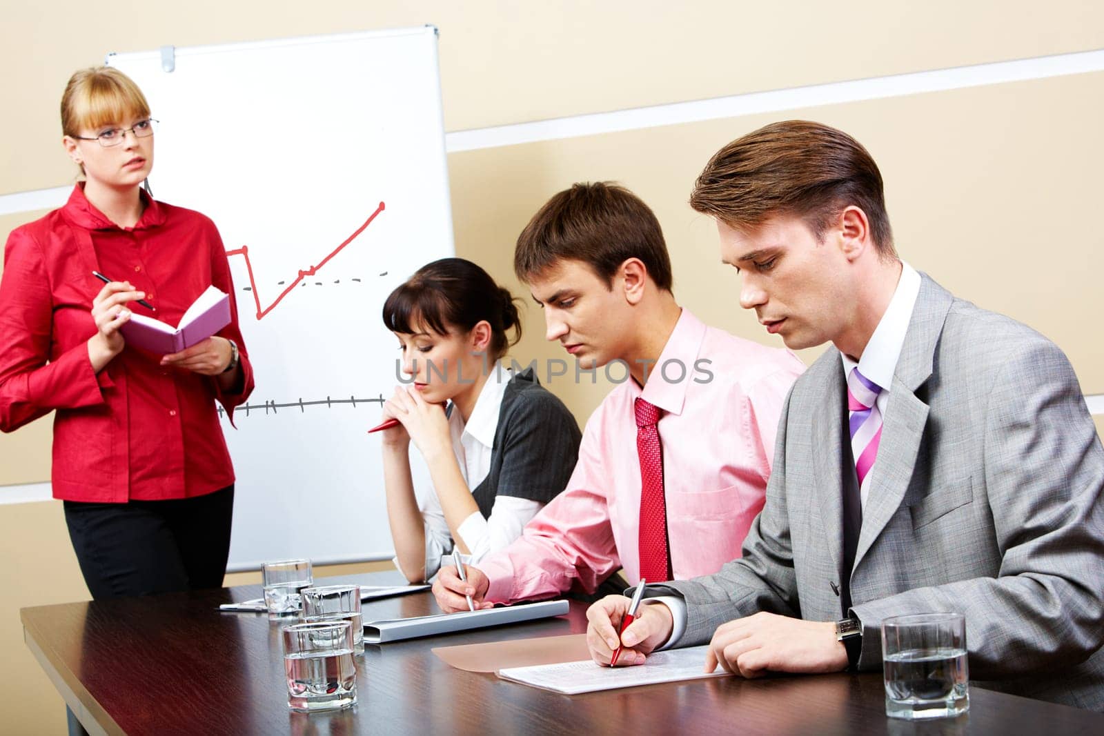 Image of smart teacher looking at students in workshop