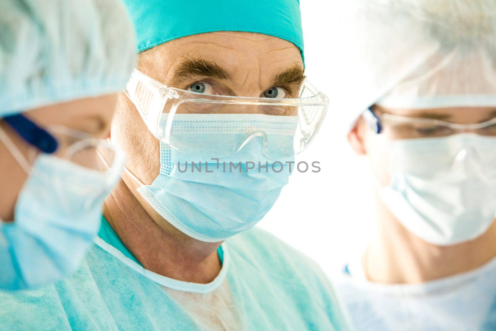 Portrait of senior doctor looking at camera through eyeglasses