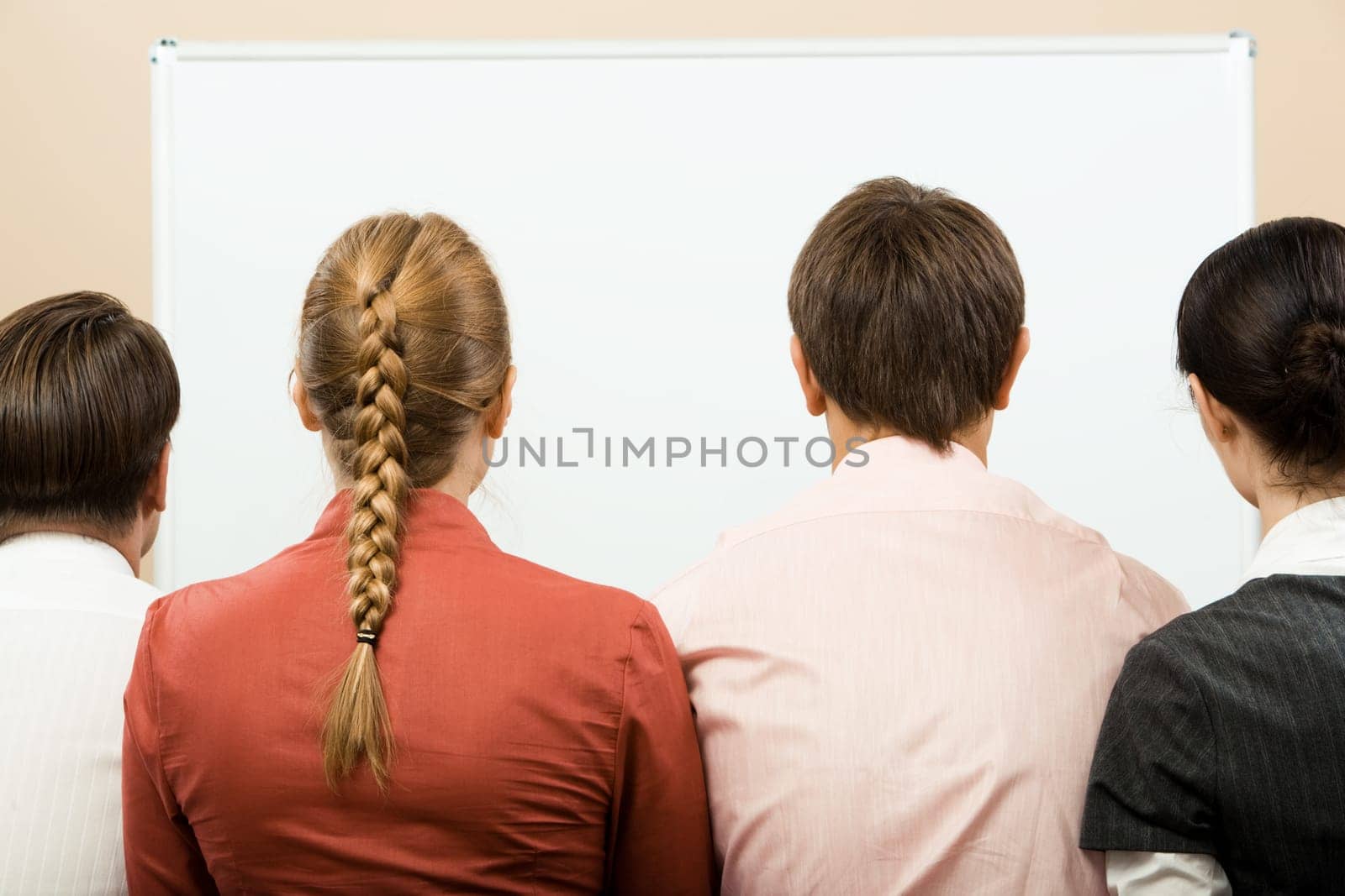 Rear view of business team with whiteboard in front of them