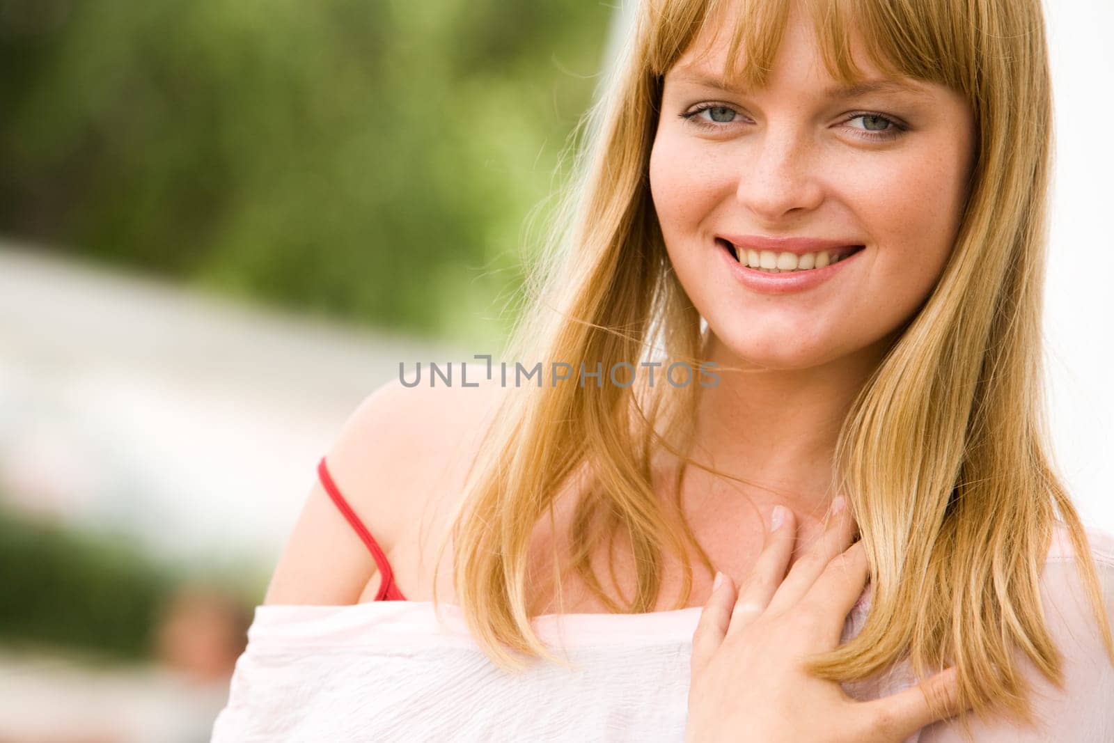 Photo of attractive blond lady looking at camera with smile