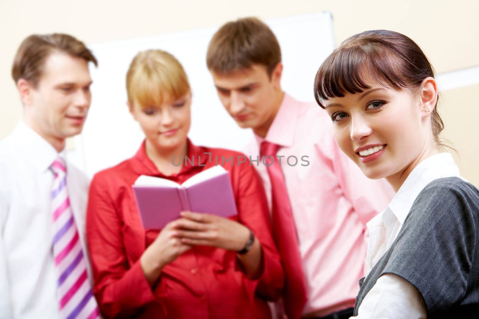 Face of young employee looking at camera with smile