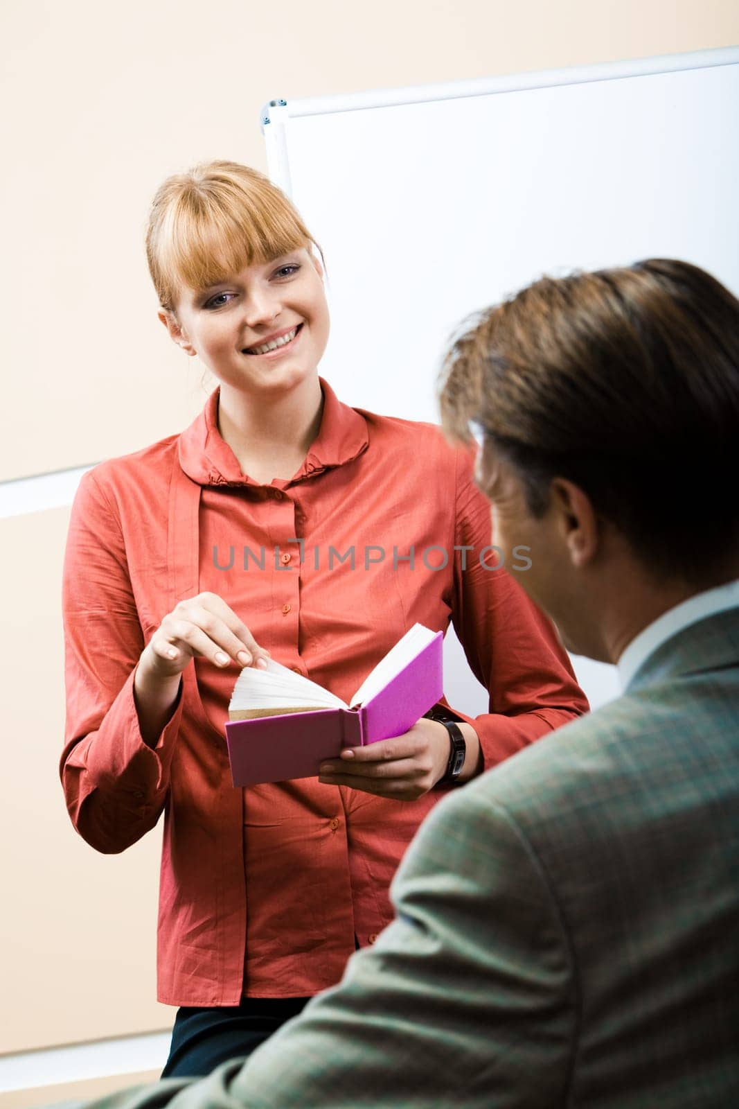 Friendly woman looking at her companion with smile during conversation
