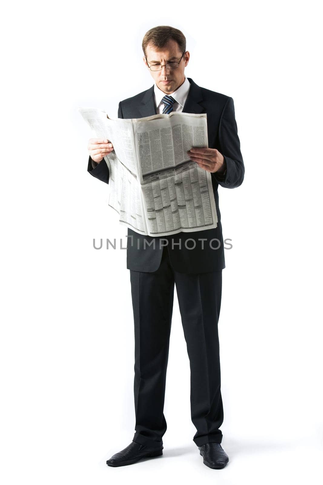 Vertical image of successful boss reading newspaper in studio