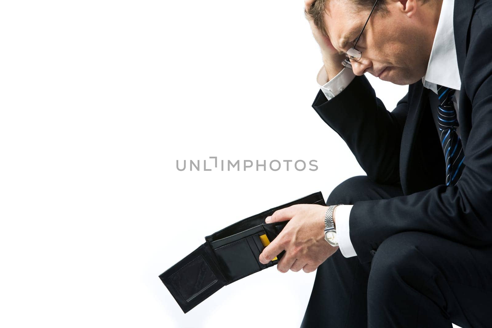 Image of sad businessman holding empty wallet and grieving