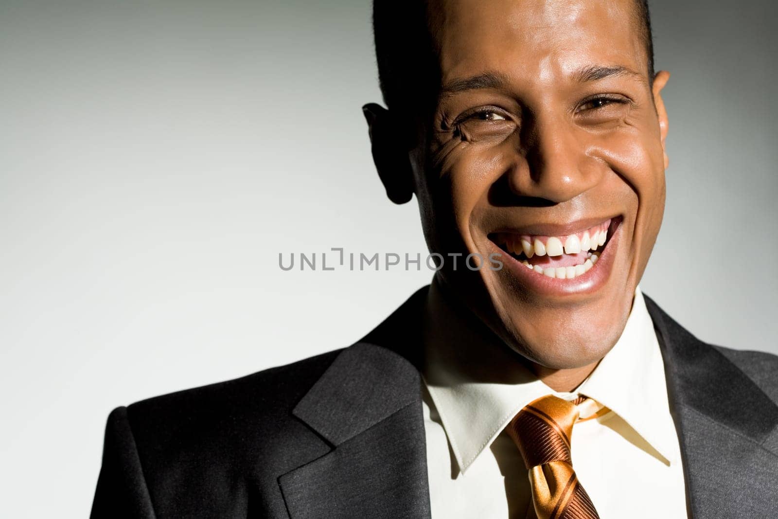 Portrait of attractive man looking at camera and laughing