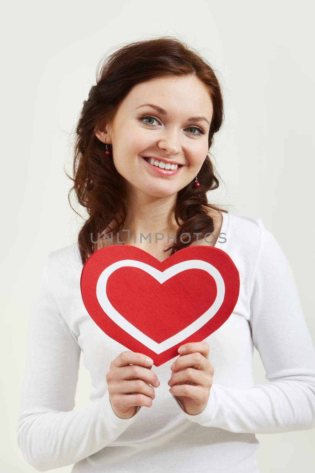 Portrait of a woman holding paper heart