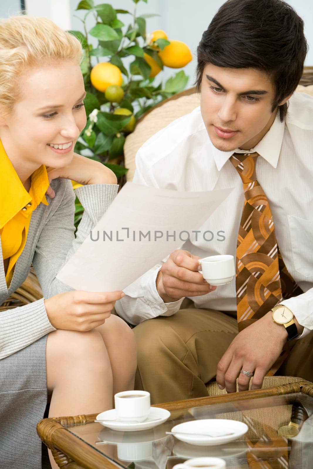 Portrait of co-workers reading business document at meeting