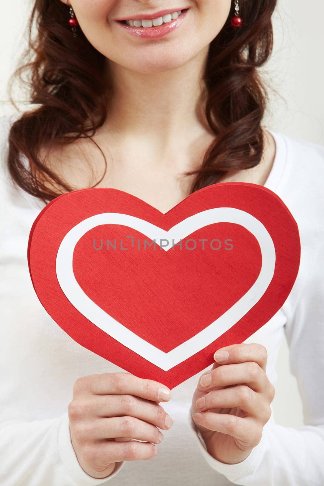 Close-up of female hands holding paper heart