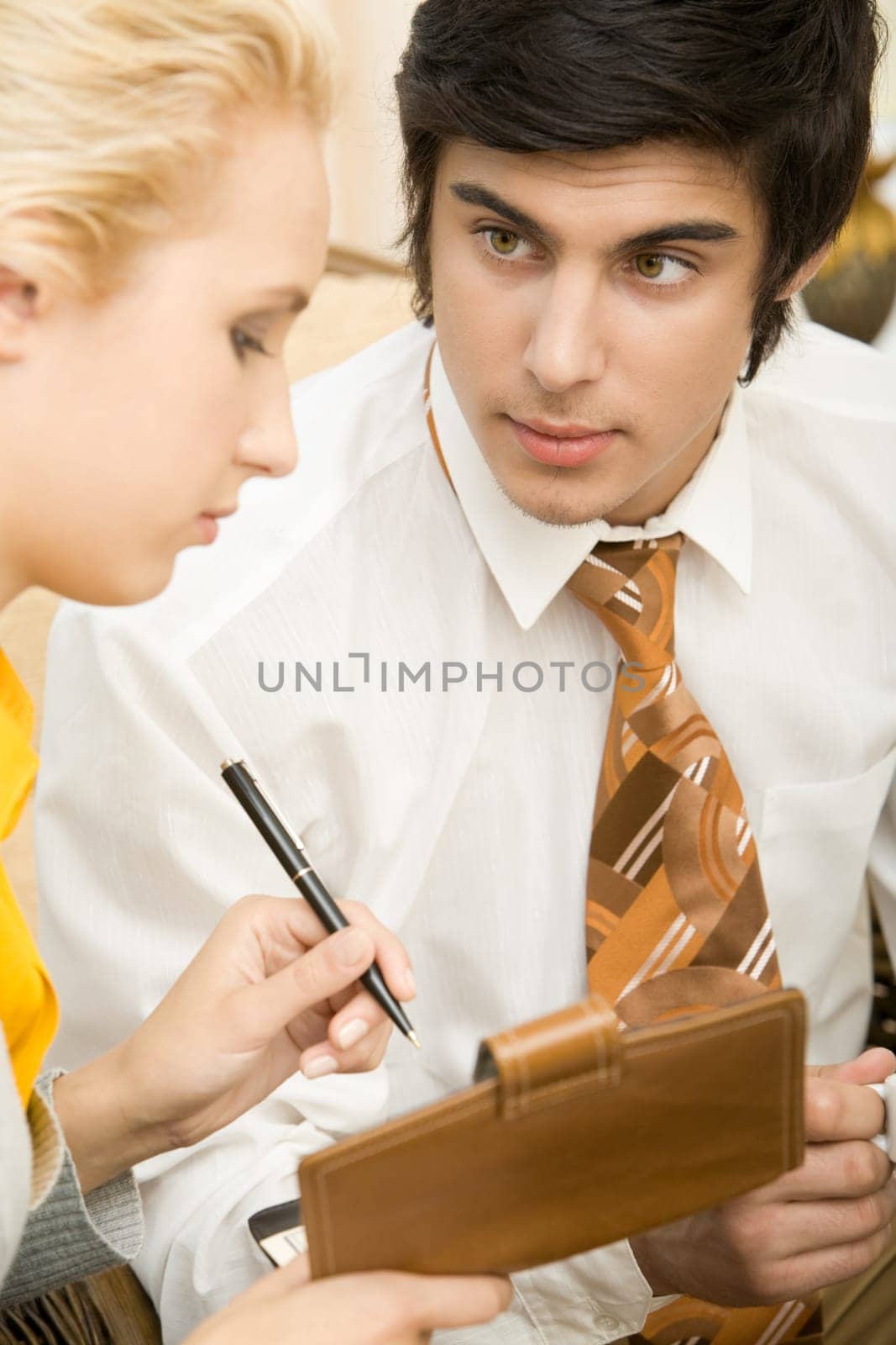 Portrait of confident businessman looking at his partner during explanation