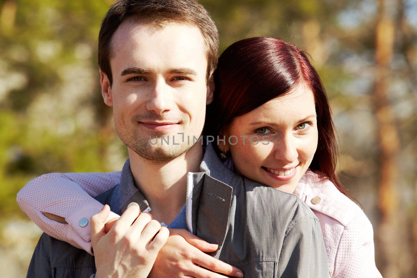 Close-up of happy couple looking at camera close to each other