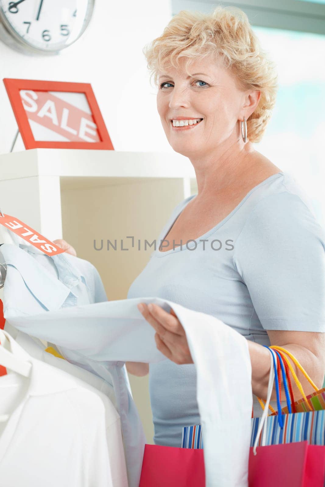 Portrait of middle aged customer looking at camera in clothing department