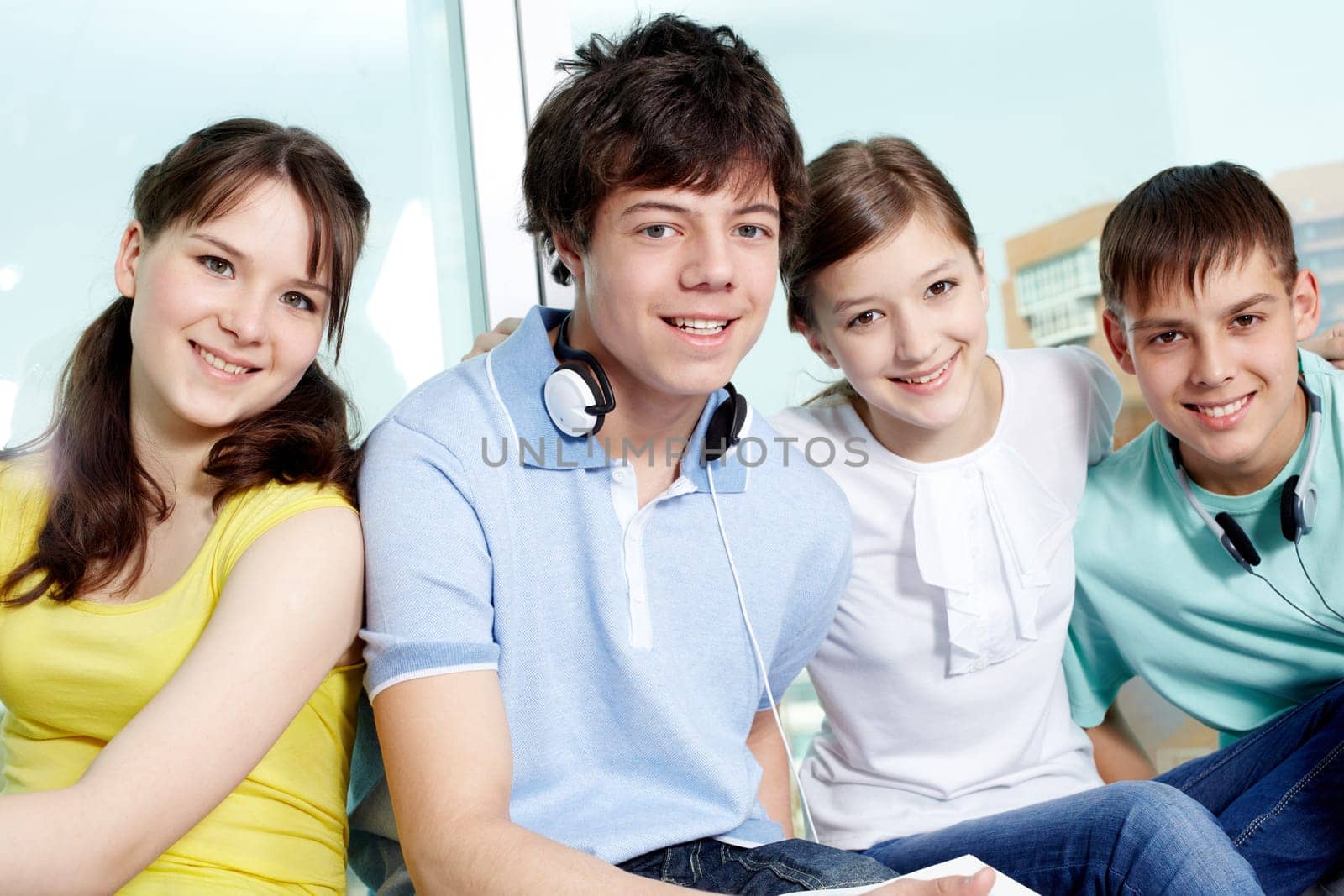 Portrait of four smiling teenagers looking at camera