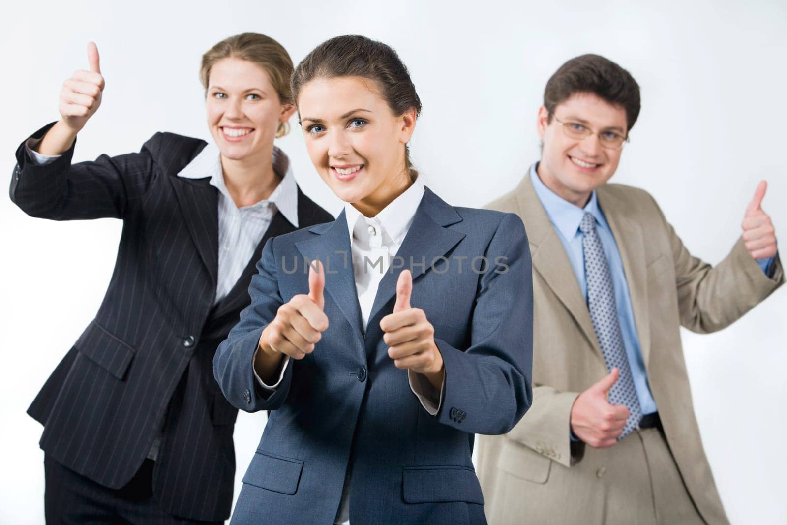 Portrait of successful business team showing sign of okay