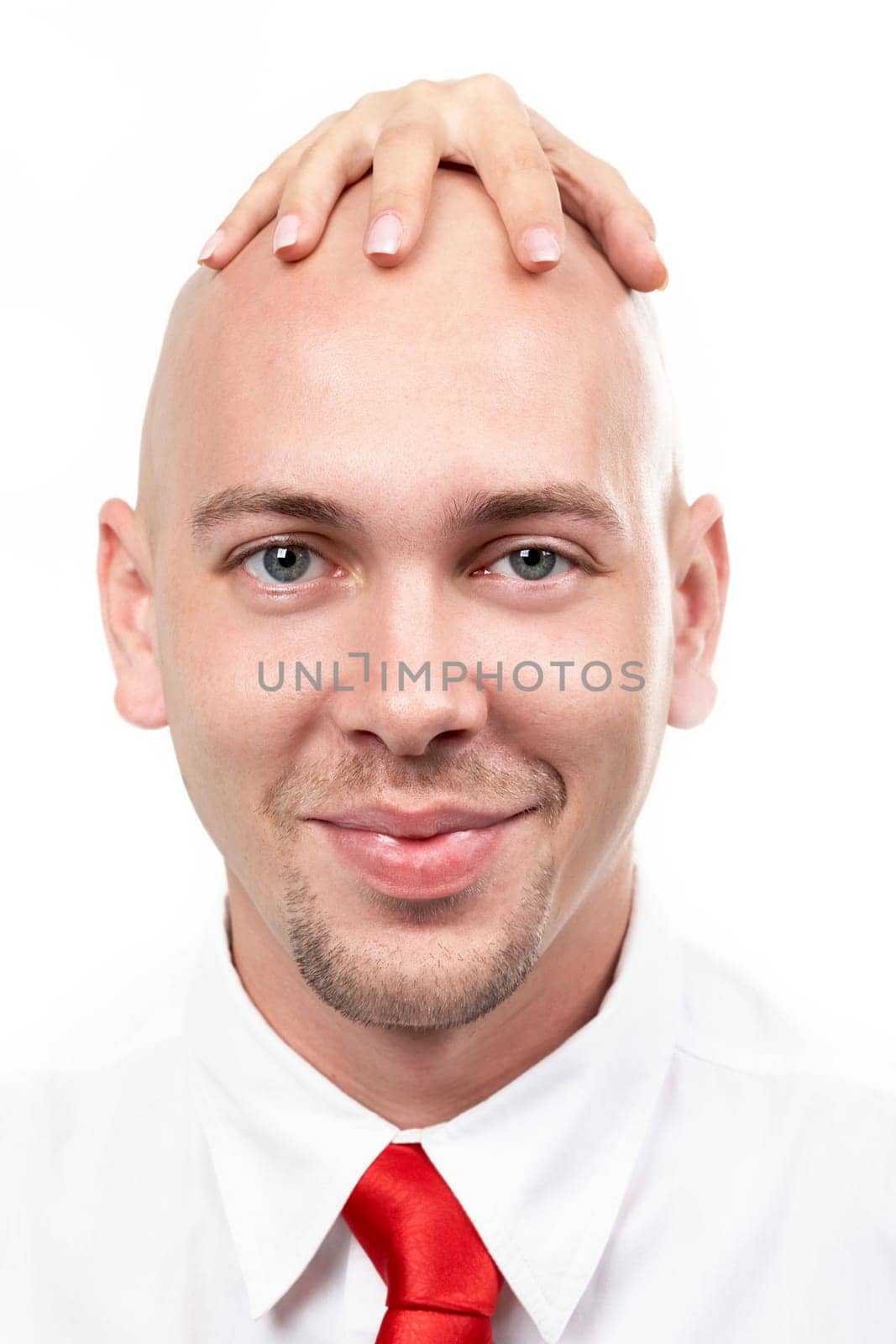 Portrait of bald man with female hand on his head