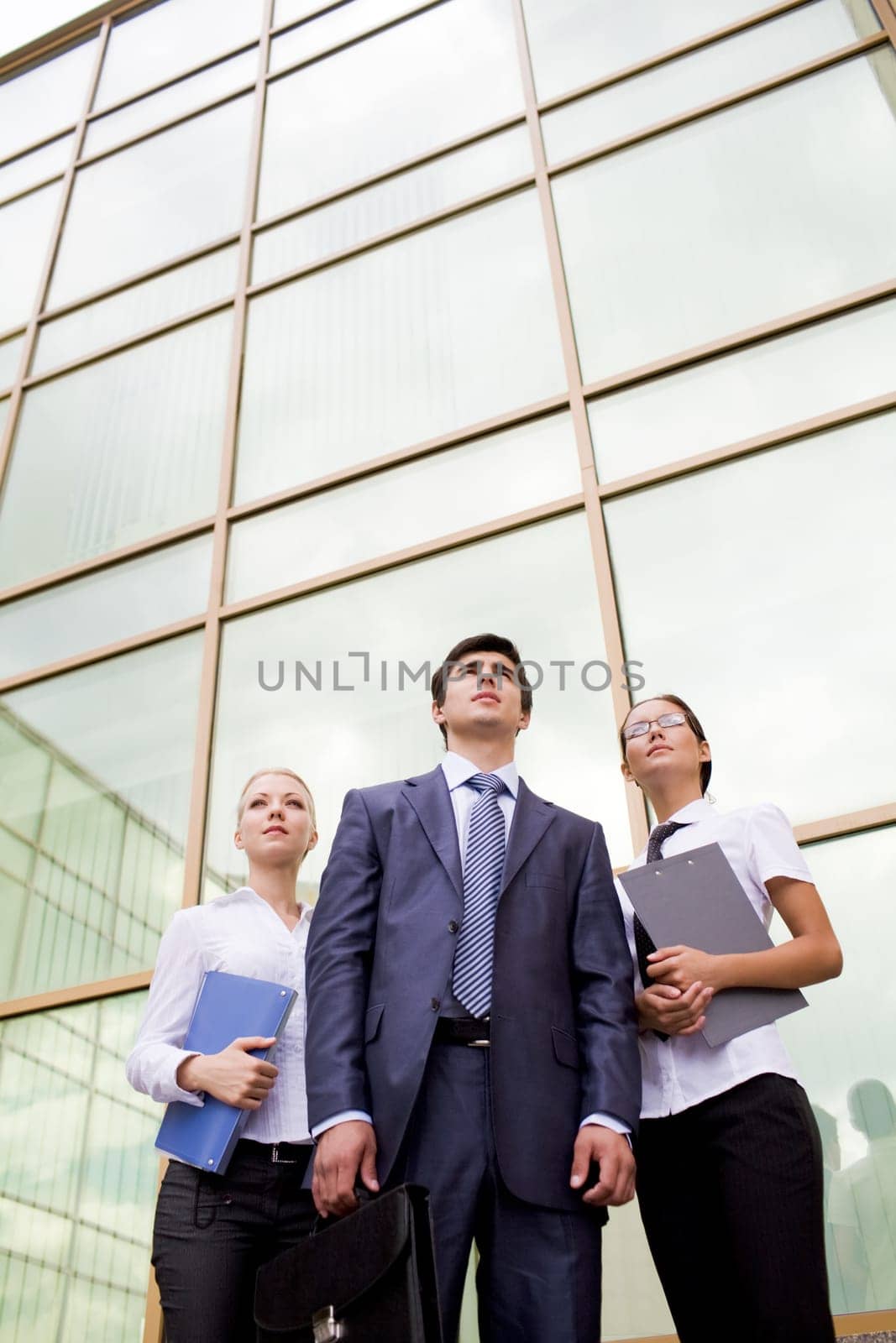 Portrait of confident business group on background of office building